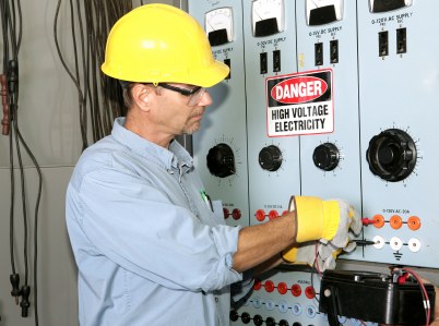 PTI Electric, Plumbing, & HVAC industrial electrician working with high voltage.